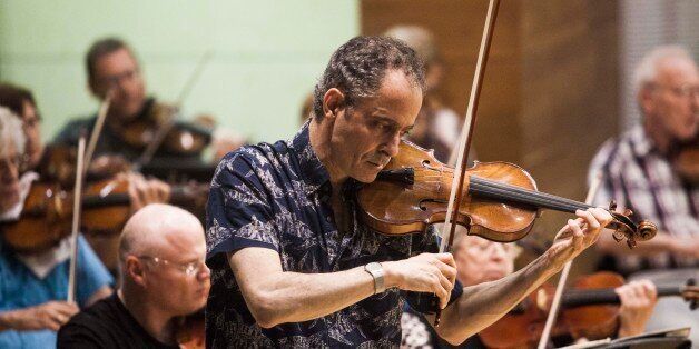 In this photo taken Wednesday, May 27, 2015, Grammy Award-winning American violinist Eugene Drucker, plays his violin during a rehearsal concert at the Music Hall in Raanana, central Israel. In 1933, the violinist Ernest Drucker left the stage midway through a Brahms concerto in Cologne at the behest of Nazi officials, in one of the first anti-Semitic acts of the new regime. Now, more than 80 years later, his son, Eugene, has completed his fatherâs interrupted work. With tears in his eyes,