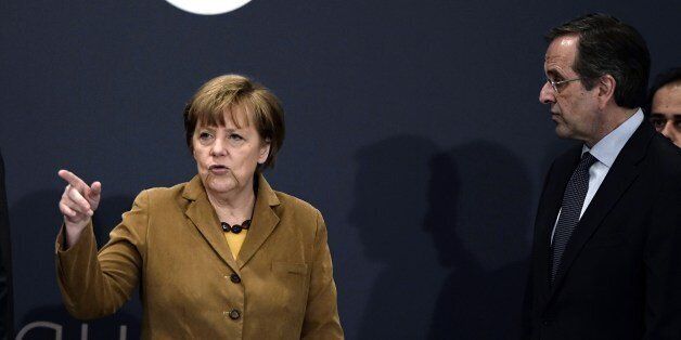 German Chancellor Angela Merkel (L) talks with Greece's Prime minister Antonis Samaras upon their arrival for a meeting with young Greek businessmen in a hotel in Athens on April 11, 2014. Merkel is in Greece on April 11 to applaud reform efforts, a day after the eurozone laggard made a triumphant return to bond markets. In her second visit to Athens in two years, Merkel was expected to discuss Germany's contribution to a 500-million-euro ($690-million) investment fund to help the Greek economy