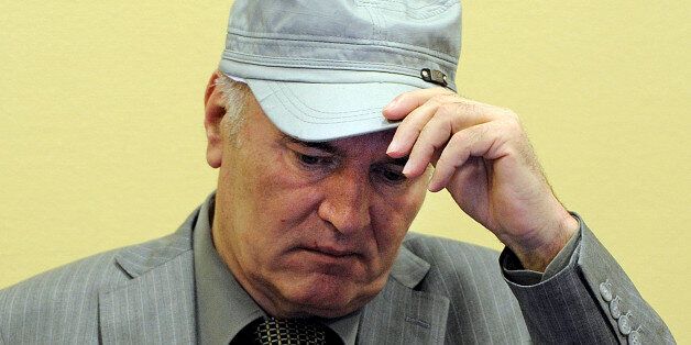 FILE - In this June 3, 2011 file photo, former Bosnian Serb Gen. Ratko Mladic removes his hat in the court room during his initial appearance at the U.N.'s Yugoslav war crimes tribunal in The Hague, Netherlands. Former Bosnian Serb military chief Ratko Mladic was hospitalized Thursday July 12, 2012 after complaining of feeling unwell at his genocide trial. Mladic was checked by a nurse at the tribunal after feeling ill and then sent to hospital