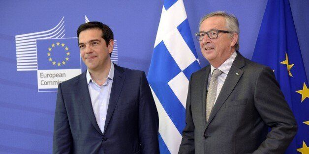 Prime Minister of Greece Alexis Tsipras (L) stands next to European Union Commission President Jean-Claude Juncker prior to their meeting at the European Union Commission headquarter in Brussels, on June 3, 2015. Greek Prime Minister Alexis Tsipras heads for last-ditch talks with European Commission chief Jean-Claude Juncker in Brussels to seal a desperately-needed bailout deal despite pessimism from hardline Germany. AFP PHOTO / THIERRY CHARLIER (Photo credit should read THIERRY CHARLIER