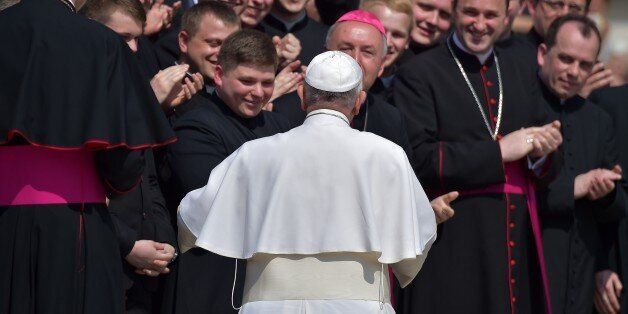 Pope Francis greets priests on April 15, 2014 during his weekly general audience at the Vatican. AFP PHOTO / VINCENZO PINTO (Photo credit should read VINCENZO PINTO/AFP/Getty Images)