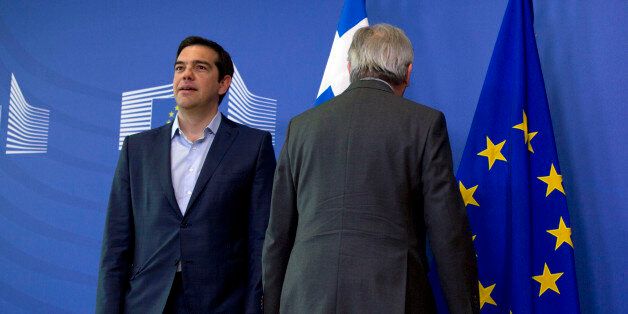European Commission President Jean-Claude Juncker, right, stands next to Greek Prime Minister Alexis Tsipras as they arrive for a meeting at EU headquarters in Brussels on Wednesday, June 3, 2015. Greece's prime minister meets European Commission President Jean-Claude Juncker in Brussels on Wednesday, June 3, 2015 to discuss his radical left-led government's proposal to secure a vital, long-overdue agreement with the country's bailout lenders. (AP Photo/Virginia Mayo)
