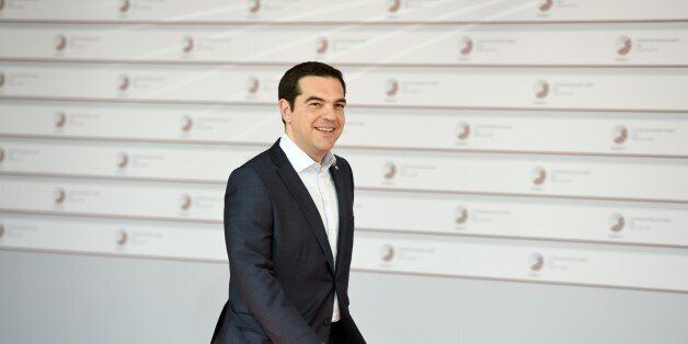 Greek Prime Minister Alexis Tsipras arrives at the House of the Blackhead for an informal dinner at the start of the fourth European Union (EU) eastern Partnership Summit in Riga, on May 21, 2015 as Latvia holds the rotating presidency of the EU Council. EU leaders and their counterparts from Ukraine and five ex-Soviet states hold a summit focused on bolstering their ties, an initiative that has been undermined by Russia's intervention in Ukraine. AFP PHOTO / ALAIN JOCARD (Photo credit s