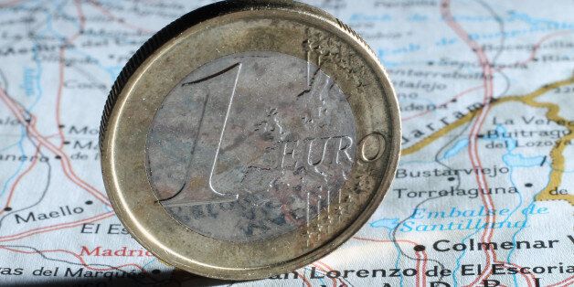 BERLIN, GERMANY - AUGUST 06: In this photo illustration a one Euro coin stands on a map of Spain next to Madrid on August 6, 2012 in Berlin, Germany. The Spanish government is considering further measures to save money in an effort to combat its debt crsis that have made its borrowing rates rise dramatically in recent weeks. (Photo Illustration by Sean Gallup/Getty Images)