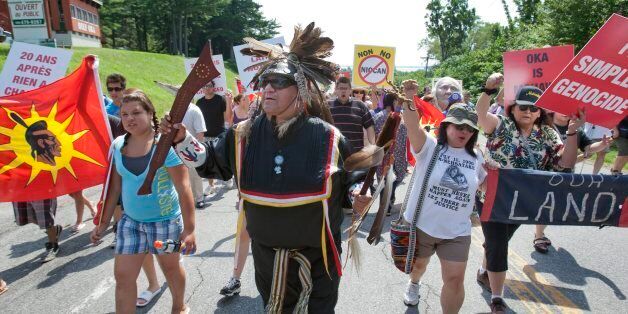 Kevin Daniels, from the Plains Cree nation in Saskatchewan, joins Mohawks in a peace march past the Oka golf course Sunday, July 11, 2010 in Oka, Que., north of Montreal. Sunday marks twenty years since the start of what became known as the Oka Crisis when a Quebec police officer was killed in a raid over disputed land that triggered a 90 day standoff with the Canadian military. (AP Photo/The Canadian Press, Ryan Remiorz)