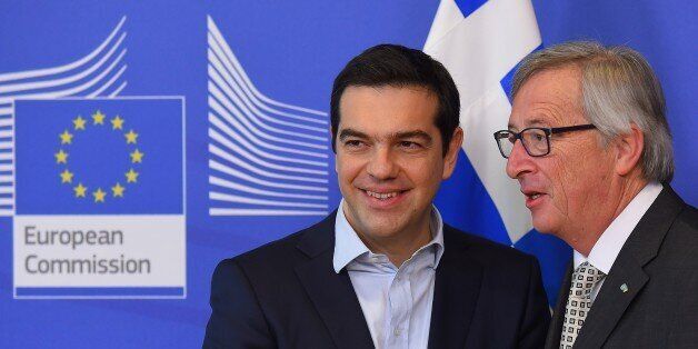Greece's Prime Minister Alexis Tsipras (L) is welcome by European Commission President Jean-Claude Juncker at the European Commission in Brussels on March 13, 2015. Tsipras is in Brussels for talks on Athens' debt-hit bailout. AFP PHOTO/Emmanuel Dunand (Photo credit should read EMMANUEL DUNAND/AFP/Getty Images)