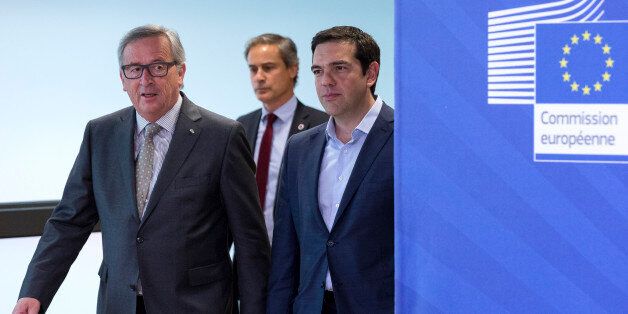 European Commission President Jean-Claude Juncker, left, walks with Greek Prime Minister Alexis Tsipras, right, as they arrive for a meeting at EU headquarters in Brussels on Wednesday, June 3, 2015. Greece's prime minister meets European Commission President Jean-Claude Juncker in Brussels on Wednesday, June 3, 2015 to discuss his radical left-led government's proposal to secure a vital, long-overdue agreement with the country's bailout lenders. (AP Photo/Thierry Monasse)