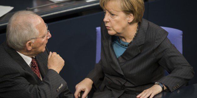 German Chancellor Angela Merkel (R) speaks with German Finance minister Wolfgang Schaeuble during a session at the Bundestag, Germany's lower house of parliament in Berlin on November 6, 2014. AFP PHOTO / ODD ANDERSEN (Photo credit should read ODD ANDERSEN/AFP/Getty Images)