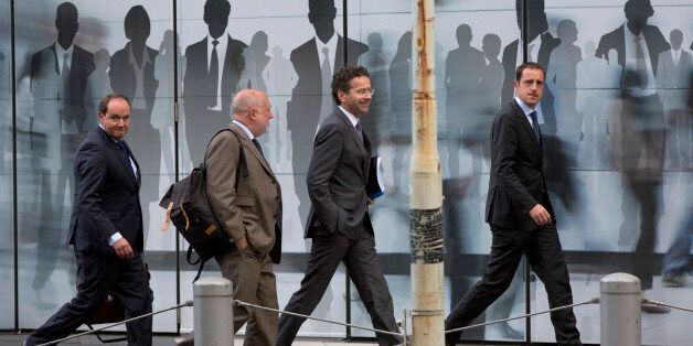 Dutch Finance Minister Jeroen Dijsselbloem, center right, walks with officials as he arrives for a meeting at EU headquarters in Brussels on Wednesday, June 3, 2015. Dijsselbloem is Brussels on Wednesday joining discussions regarding the Greek bailout. (AP Photo/Virginia Mayo)