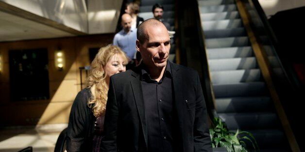 Greek Finance Minister Yanis Varoufakis, right, arrives at an economic conference in Athens, on Tuesday, May 14, 2015. Varoufakis said Thursday that he will reject any deal with bailout creditors unless it helps Greece escape from its financial crisis. (AP Photo/Petros Giannakouris)