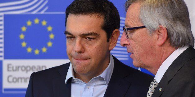 Greece's Prime Minister Alexis Tsipras (L) is welcome by European Commission President Jean-Claude Juncker at the European Commission in Brussels on March 13, 2015. Tsipras is in Brussels for talks on Athens' debt-hit bailout. AFP PHOTO/Emmanuel Dunand (Photo credit should read EMMANUEL DUNAND/AFP/Getty Images)