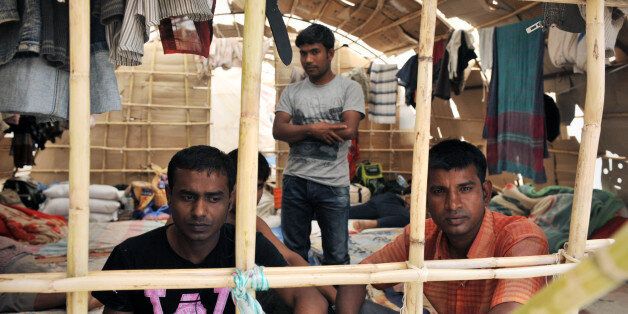 Migrant workers sit inside a makeshift camp in Nea Manolada on April 18, 2013. Police in Greece have arrested two men in connection with an alleged attack by strawberry growers on unpaid migrant labourers that left 27 injured, one of them in critical condition, local authorities said on April 18. The migrants, mainly from Bangladesh, were hospitalised in the western port of Patras and other areas with gunshot wounds after allegedly being fired upon late on April 17 by three growers in the village of Manolada, one of the main areas of strawberry production in Greece. AFP PHOTO/ GIOTA KORBAKI (Photo credit should read GIOTA KORBAKI/AFP/Getty Images)