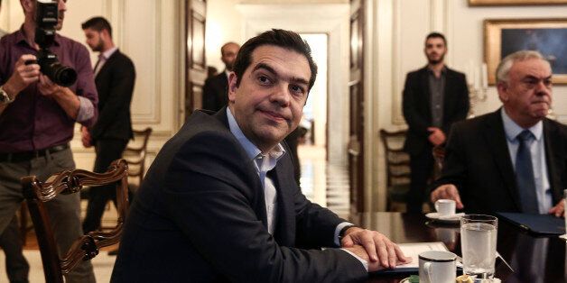 Greece's Prime Minister Alexis Tsipras, center, looks on during a meeting with Iranian Foreign Minister Mohammad Javad Zarif in Athens, Greece, on Thursday, May 28, 2015. Greece says it aims to clinch a deal with its creditors by Sunday, a development that would allow it to receive the desperately needed final installment of its international bailout plan and prevent a default. (AP Photo/Yorgos Karahalis)