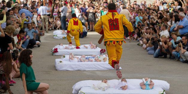 CASTRILLO DE MURCIA, SPAIN - JUNE 22: A man representing the devil leaps over babies during the festival of El Salto del Colacho (the devil's jump) on June 22, 2014 in Castrillo de Murcia, Spain. The festival, held on the first Sunday after Corpus Cristi, is a catholic rite of the devil cleansing babies of original sin. (Photo by Denis Doyle/Getty Images)