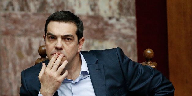 Greece's Prime Minister Alexis Tsipras gestures during a parliamentary session in Athens, on Monday, March 30, 2015, after Tsipras called the special session of parliament to brief lawmakers on the course of recent troubled negotiations with bailout lenders to overhaul cost-cutting reforms. Greece is under pressure to convince creditors it has viable alternatives to the reforms, with government cash reserves running low. (AP Photo/Petros Giannakouris)