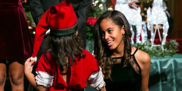 WASHINGTON, DC - DECEMBER 14: (AFP OUT) Malia Obama greets a group of 'elves' prior to the taping of TNT's 'Christmas in Washington' program on December 14, 2014 in Washington, DC. The 'elves' are former patients of Children's National Medical Center, the beneficiary of this evenings concert. (Photo by Kristoffer Tripplaar-Pool/Getty Images)