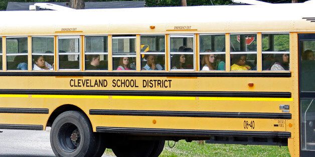 In this May 13, 2015 photo, an integrated group of Cleveland, Miss., public school students ride the bus on their way home following classes. On Monday, May 18, a five-day federal court hearing starts in Jackson and could settle whether Cleveland's two middle schools and two high schools are merged as one each as part of a 49-year-old desegregation lawsuit. (AP Photo/Rogelio V. Solis)