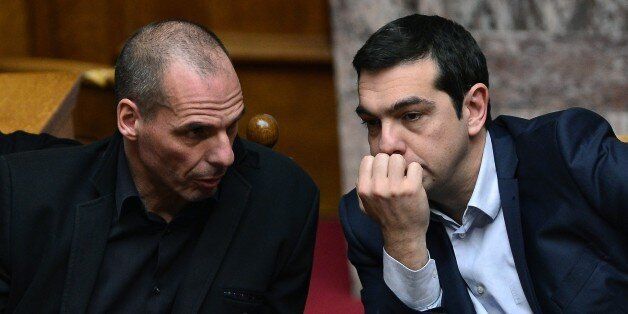 Greek Prime Minister Alexis Tsipras (R) listens to his Finance Minister Yianis Varoufakis during the vote for the president, at the Greek parliament in Athens, on February 18, 2015. Greece's parliament elected pro-European conservative Prokopis Pavlopoulos as the country's new president, a move calculated to bolster the hard-left government in its critical EU bailout talks. AFP PHOTO / LOUISA GOULIAMAKI (Photo credit should read LOUISA GOULIAMAKI/AFP/Getty Images)