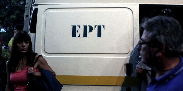 A woman stands in front of a van of the Greek state television ERT headquarters on June 16, 2013 in Athens. European Broadcasting Union (EBU) asked Greece to re-open public broadcaster ERT after the government's surprise decision to pull it off the air in a bid to cut spending sparked a nationwide strike. Greek Prime Minister Antonis Samaras on June 14 offered to partially reinstate state broadcaster ERT after a backlash over its dramatic closure threatened to derail his government. AFP PHOTO / ANGELOS TZORTZINIS (Photo credit should read ANGELOS TZORTZINIS/AFP/Getty Images)