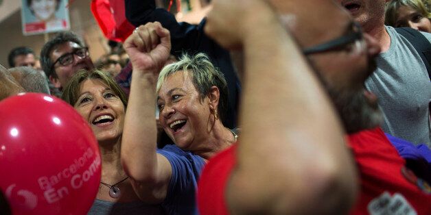 Supporters of the leader of leftist coalition Barcelona Together, Ada Colau, celebrate the victory of their party after elections in Barcelona, Spain, Sunday, May 24, 2015. New parties won strong support in Spain's local elections Sunday as voters turned their back on the country's traditional political heavyweights, an exit poll indicated. There was also an upset in Barcelona, where a popular anti-eviction campaigner backed by We Can was poised to unseat the region's long dominant and conservat