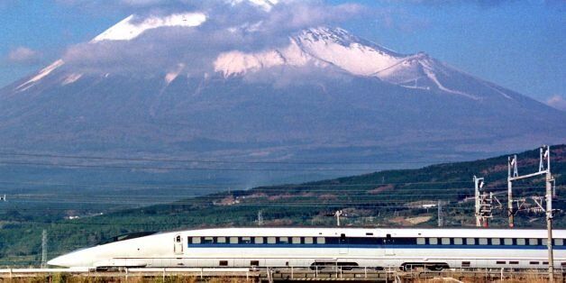 SHIZUOKA, JAPAN: This recent file picture shows a bullet train 500-type speeding in front of Mt. Fuji in Shizuoka. AFP PHOTO (Photo credit should read AFP/AFP/Getty Images)