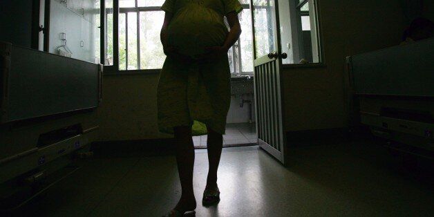 WUHAN, CHINA - JUNE 25: (CHINA OUT) Deng Qin walks a corridor at Tongji Hospital June 25, 2007 in Wuhan of Hubei Province, China. The 23-year-old farmer, who is 32 weeks pregnant with quadruplets, has a medical team organized by the hospital to handle delivery of the babies. Doctors are scheduled to perform a Caesarean section on June 28. (Photo by China Photos/Getty Images)