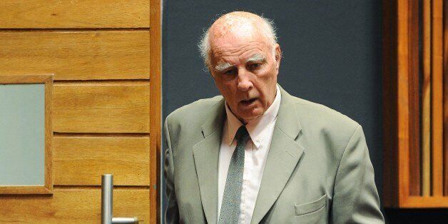 Australian-born former tennis Grand Slam champion Bob Hewitt walks through the Palm Ridge court where he was found guilty of rape and indecent assault on March 23, 2015 in Johannesburg. Australian-born former tennis Grand Slam champion Bob Hewitt was found guilty Monday in South Africa of raping and assaulting young girls whom he was coaching in the early 1980s. Hewitt, 75, had pleaded not guilty to the two charges of rape and one of indecent assault, which were brought against him by three women in 2013. AFP PHOTO / GORDON HARNOLS (Photo credit should read GORDON HARNOLS/AFP/Getty Images)