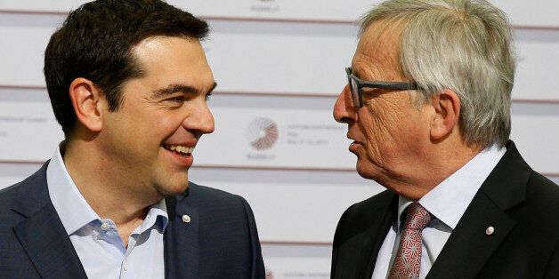 European Commission President Jean-Claude Juncker, right, speaks with Greek Prime Minister Alexis Tsipras during arrivals at the Eastern Partnership summit in Riga, Latvia on Friday, May 22, 2015. EU leaders gather for a second day of meetings with six post-communist nations to discuss various issues, including enlargement, the economy and Ukraine. (AP Photo/Mindaugas Kulbis)