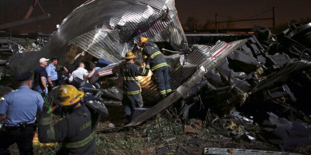 Emergency personnel work the scene of a train wreck, Tuesday, May 12, 2015, in Philadelphia. An Amtrak train headed to New York City derailed and crashed in Philadelphia. (AP Photo/Joseph Kaczmarek)