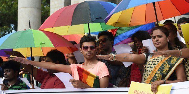 Indian gay rights activists belonging to the Karnataka Sexual Minorities Forum (KSMF) take oath to fight together during a protest to demand the repeal of IPC 377 in Bangalore on July 2, 2014. The activists during the protest urged Karnataka Police to withdraw any false and fabricated cases filed against sexual miniroties. AFP PHOTO/Manjunath KIRAN (Photo credit should read Manjunath Kiran/AFP/Getty Images)