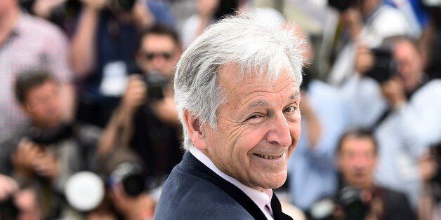 Greek director Costa-Gavras smiles during a photocall for the sidebar section 'Cannes Classics' at the 68th Cannes Film Festival in Cannes, southeastern France, on May 18, 2015. AFP PHOTO / ANNE-CHRISTINE POUJOULAT (Photo credit should read ANNE-CHRISTINE POUJOULAT/AFP/Getty Images)