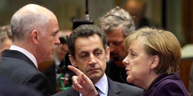 German Chancellor Angela Merkel, right, speaks with Greek Prime Minister George Papandreou, left, and French President Nicolas Sarkozy during a round table meeting at an EU summit in Brussels, Friday, Feb. 4, 2011. EU leaders meet for a one-day summit on Friday, with energy, the eurozone debt crisis and unrest in Egypt set to dominate the agenda. (AP Photo/Yves Logghe)