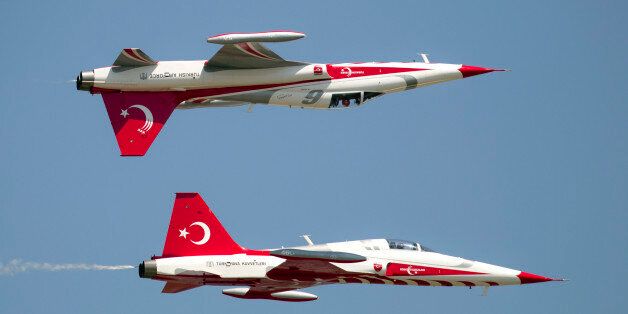 Aircraft of the Turkish Stars, Turkey's Air Force demonstration team, perform during an air show in Bucharest, Romania, Saturday, July 21, 2012. (AP Photo/Vadim Ghirda)