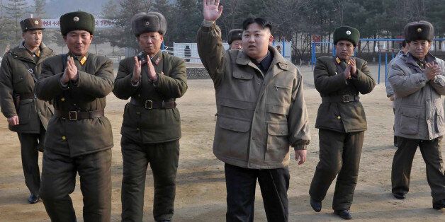 In this undated file photo released by the Korean Central News Agency and distributed in Tokyo by the Korea News Service on Thursday, Jan. 19, 2012, North Korean leader Kim Jong Un, center, raises his arm at an undisclosed location in North Korea. North Korea on Friday Jan. 20, 2012, credited new leader Kim Jong Un with spearheading past nuclear testing, as it adds to a growing personality cult that portrays the young son of late leader Kim Jong Il as a confident military commander. (AP Photo/Korean Central News Agency via Korea News Service, File) JAPAN OUT UNTIL 14 DAYS AFTER THE DAY OF TRANSMISSION