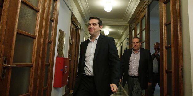 Greek Prime Minister Alexis Tsipras arrives at a cabinet meeting in central Athens, on Tuesday, May 12, 2015. Officials say Greece has completed a 757 million euro ($844 million) debt payment to the International Monetary Fund, despite an acute cash shortage that could come to a head within the next two weeks. (AP Photo/Petros Giannakouris)