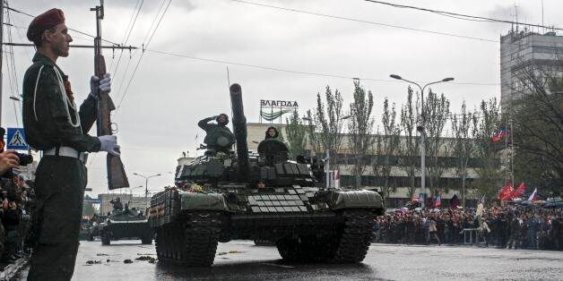 A military parade marking the 70th anniversary of the victory over Nazi Germany in WWII is held in Donetsk, eastern Ukraine, Saturday, May 9, 2015. Russia-backed separatist fighters took part in the parade. (AP Photo/Vasiliy Kolotilov)