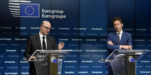 EU Commissioner of Economic an d Financial Affairs, Taxation and Customs Pierre Moscovici (L) and Dutch Finance Minister and president of Eurogroup Jeroen Dijsselbloem give a joint press conference after an Eurogroup Council meeting on May 11, 2015 at EU Headquarters in Brussels. AFP PHOTO/JOHN THYS (Photo credit should read JOHN THYS/AFP/Getty Images)