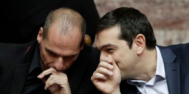 Greece's Prime Minister Alexis Tsipras talks with Greece's Finance Minister Yanis Varoufakis, left, during a Presidential vote in Athens, on Wednesday, Feb. 18, 2015. Greeceâs parliament has elected conservative law professor and veteran politician Prokopis Pavlopoulos as the countryâs next president, after he received support from the new left-wing government and main center-right opposition party.(AP Photo/Petros Giannakouris)
