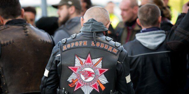 Sympathisers and members of the Russian biker group Night Wolves stand together on the grounds of the Federal Police near the BAB 17 highway in Breitenau, eastern Germany, on May 7, 2015 (text on the biker's jacket in C reads: 'Russian Bikers' and 'Ways of Victory'). The pro-Kremlin Night Wolves' ride to Berlin ahead of the anniversary of Soviet victory in World War II was delayed due to controls at the Federal Police. The Russian bikers originally planned to retrace the 6,000-kilometre (3,730-mile) march of Soviet troops through Belarus, Poland, the Czech Republic, Slovakia and Austria, but the riders were forbidden to cross the Polish border at the end of April 2015. AFP PHOTO / DPA / ARNO BURGI +++ GERMANY OUT (Photo credit should read ARNO BURGI/AFP/Getty Images)