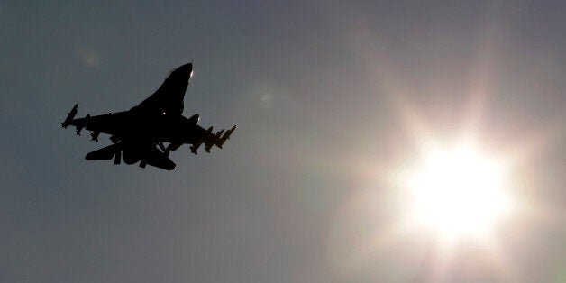 An F-16 jet fighter flies over the NATO airbase in Aviano, Italy, Monday, March 21, 2011. Italy is warning that it will review the use of its bases by coalition forces for strikes against Libya if the mission doesn't pass to NATO's command. Italian Foreign Minister Franco Frattini issued the ultimatum Monday after Turkey blocked NATO from approving a military strategy that would allow NATO's participation in the operation. Italy has allowed seven military bases to be used, and six Italian Tornados took part in operations over Libya on Sunday. (AP Photo/Luca Bruno)