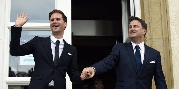 Luxembourg Prime Minister Xavier Bettel (R) holds hands with his companion Belgian architect Gauthier Destenay during their wedding in Luxembourg on May 15, 2015. Luxembourg Prime Minister Xavier Bettel is to wed his gay partner today, becoming the first European Union leader to enter into a same-sex marriage, a symbol of growing social change across the continent. AFP PHOTO / JOHN THYS (Photo credit should read JOHN THYS/AFP/Getty Images)