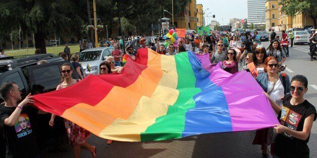 Albanian LGBT (lesbian, gay, bisexual, and transgender) activists march while holding the symbolic rainbow flag in the main boulevard of Tirana to mark the International Day Against Homophobia and Transphobia (IDAHOT) on May 17, 2015. Only in recent years has the LGBT community in Albania emerged from marginalized and underground activities to hold public events and parades, although not entirely without causing controversy and prejudice in this small Balkan nation which until the collapse of the communist regime in 1990 penalized homosexuality. AFP PHOTO / GENT SHKULLAKU (Photo credit should read GENT SHKULLAKU/AFP/Getty Images)