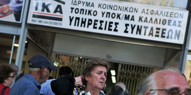 Pensioners who didn't receive their pensions wait outside IKA Greece's largest Social Security Organisation office in Athens on May 31, 2013. Hundreds of pensioners whose pensions were not payed, allegedly due to registering mistakes, gathered at IKA offices to clarify the situation. AFP PHOTO/ LOUISA GOULIAMAKI (Photo credit should read LOUISA GOULIAMAKI/AFP/Getty Images)