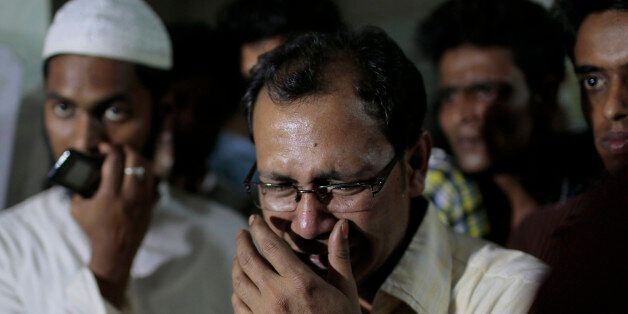 In this Monday, March 30, 2015 photo, a relative of the late Bangladeshi blogger Qyasiqur Rahman Babu cries outside a morgue at the Dhaka Medical College in Dhaka, Bangladesh. The blogger, 27, was hacked to death by three men in Bangladesh's capital on Monday, police said. The killing took place a month after a prominent Bangladeshi-American blogger known for speaking out against religious extremism was hacked to death in Dhaka. (AP Photo/A.M. Ahad)
