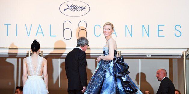 Australian actress Cate Blanchett (R) smiles as she arrives with US actress Rooney Mara (L) and US director Todd Haynes (C) for the screening of the film 'Carol' at the 68th Cannes Film Festival in Cannes, southeastern France, on May 17, 2015. AFP PHOTO / ANNE-CHRISTINE POUJOULAT (Photo credit should read ANNE-CHRISTINE POUJOULAT/AFP/Getty Images)