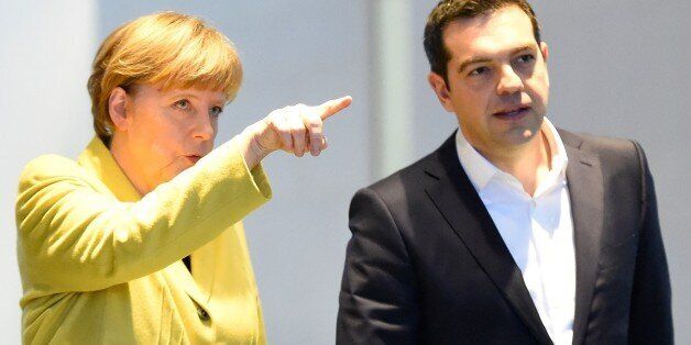 German Chancellor Angela Merkel (L) and Greek Prime Minister Alexis Tsipras arrive to address a press conference following talks at the chancellery in Berlin, on March 23, 2015. AFP PHOTO / TOBIAS SCHWARZ (Photo credit should read TOBIAS SCHWARZ/AFP/Getty Images)