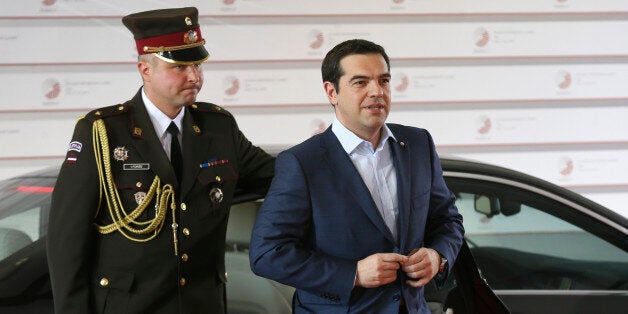 Greek Prime Minister Alexis Tsipras, right, arrives for a formal dinner at the Eastern Partnership summit in Riga, on Thursday, May 21, 2015. EU leaders on Thursday will seek new ways to bolster ties with six post-communist nations in Eastern Europe, a year and a half after a previous summit of the Eastern Partnership ended with a fateful standoff over Ukraine. (AP Photo/Mindaugas Kulbis)