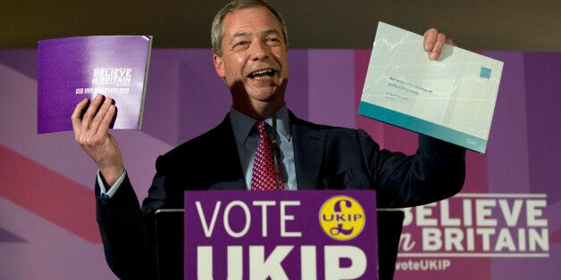 FILE - This is a Wednesday, April 15, 2015 file photo of Nigel Farage leader of the UK Independence Party as he holds up his party's election manifesto, left, and economic policy review, right, during its launch at a media event in Thurrock England. Farage â the bad boy of British politics â is trying to clean up his image ahead of the May 7 general election. His once surging party has started to languish in the polls and Farage himself admits he is in a dog-fight to try to win his first seat in the British Parliament. (AP Photo/Alastair Grant, File)