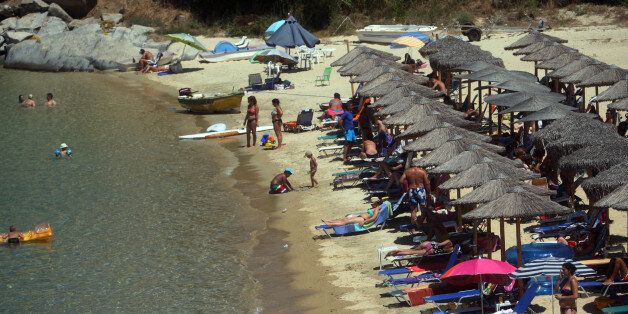 Photo taken on 23 July, 2013, shows a beach in Sikia, in Chalkidiki Peninsula some 650km north of Athens.Overall, international arrivals to Greece increased by 9.5 percent during the January-June 2013 period compared with the same period last year.Based on the above data and in view of the upcoming high summer season, industry professionals remained optimistic that this year's arrivals figures would hit the 17 million mark. AFP PHOTO /Sakis Mitrolidis (Photo credit should read SAKIS MITROLIDIS/AFP/Getty Images)