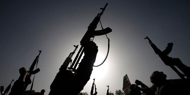 Shiite rebels known as Houthis hold up their weapons to denounce the Saudi-led airstrikes as they chant slogans during a protest in Sanaa, Yemen, Monday, April 27, 2015. Saudi-led airstrikes on Monday targeted Shiite rebels across Yemen, killing several people in the southern port city of Aden and striking a weapons depot in the rebel-held capital, officials and witnesses said. (AP Photo/Hani Mohammed)